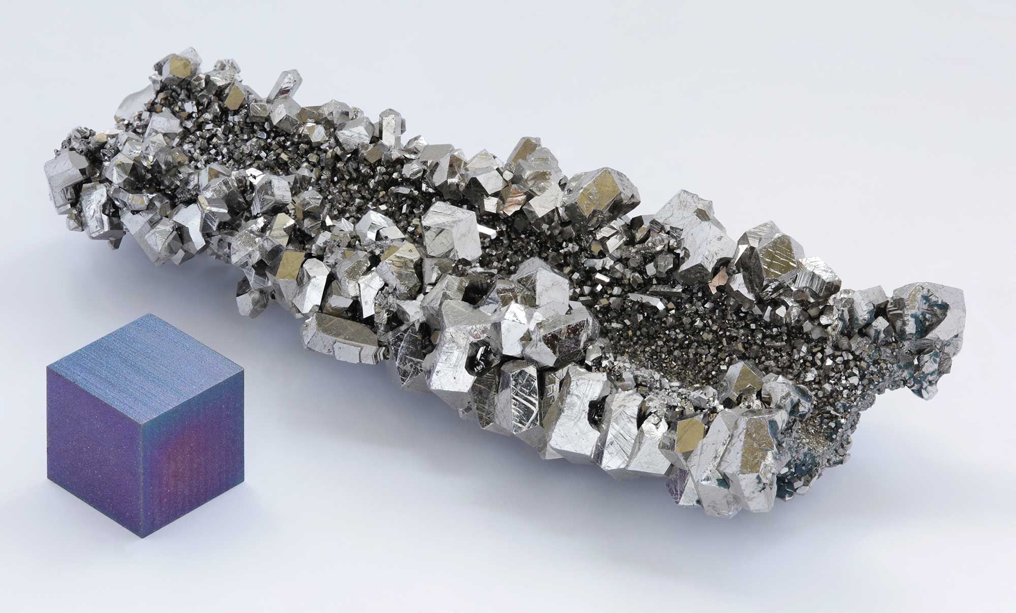 Niobium crystals next to an anodized cube of 99.95 percent pure niobium.