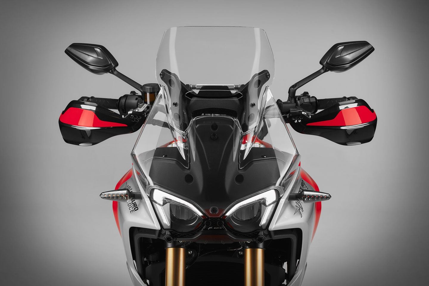 The Enduro Veloce’s upper fairing blends into the windscreen in a seamless manner for a very clean look. Hand guards are standard.