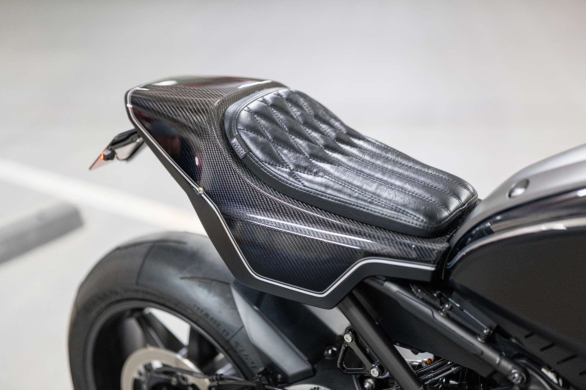 The carbon fiber tailsection comes with a stainless steel bracket underneath the upholstered seat, but will require the separate purchase of a tail tidy or license plate relocation.