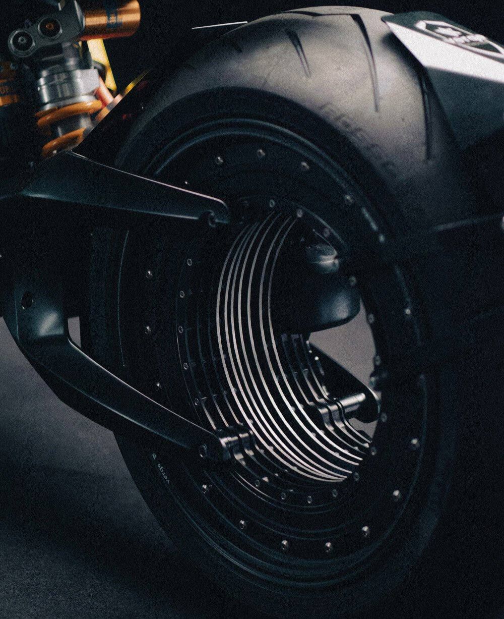 On Verge machines, the wheel <i>is</i> the motor, so power goes right to the ground. The rim contains fins to dissipate heat generated by it.