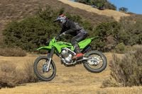 2025 Kawasaki KLX230R catching air off trail jump