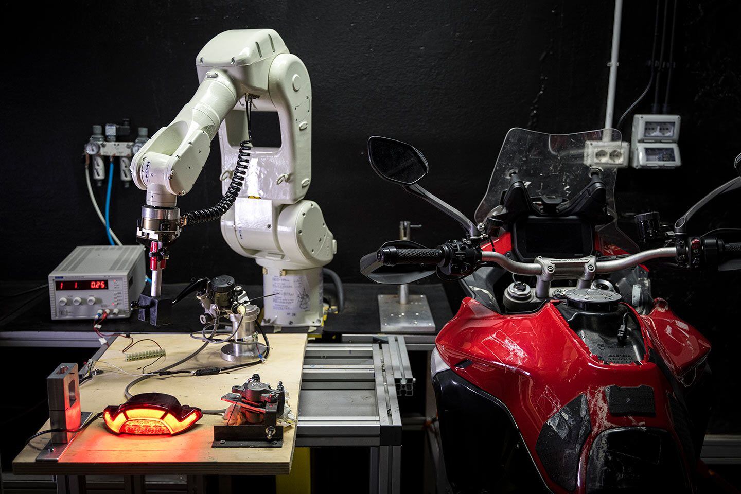 At the factory, Ducati uses robots to conduct stress tests. One such test repeatedly presses on the brake lever, actuating the brake light in order to test long-term durability.