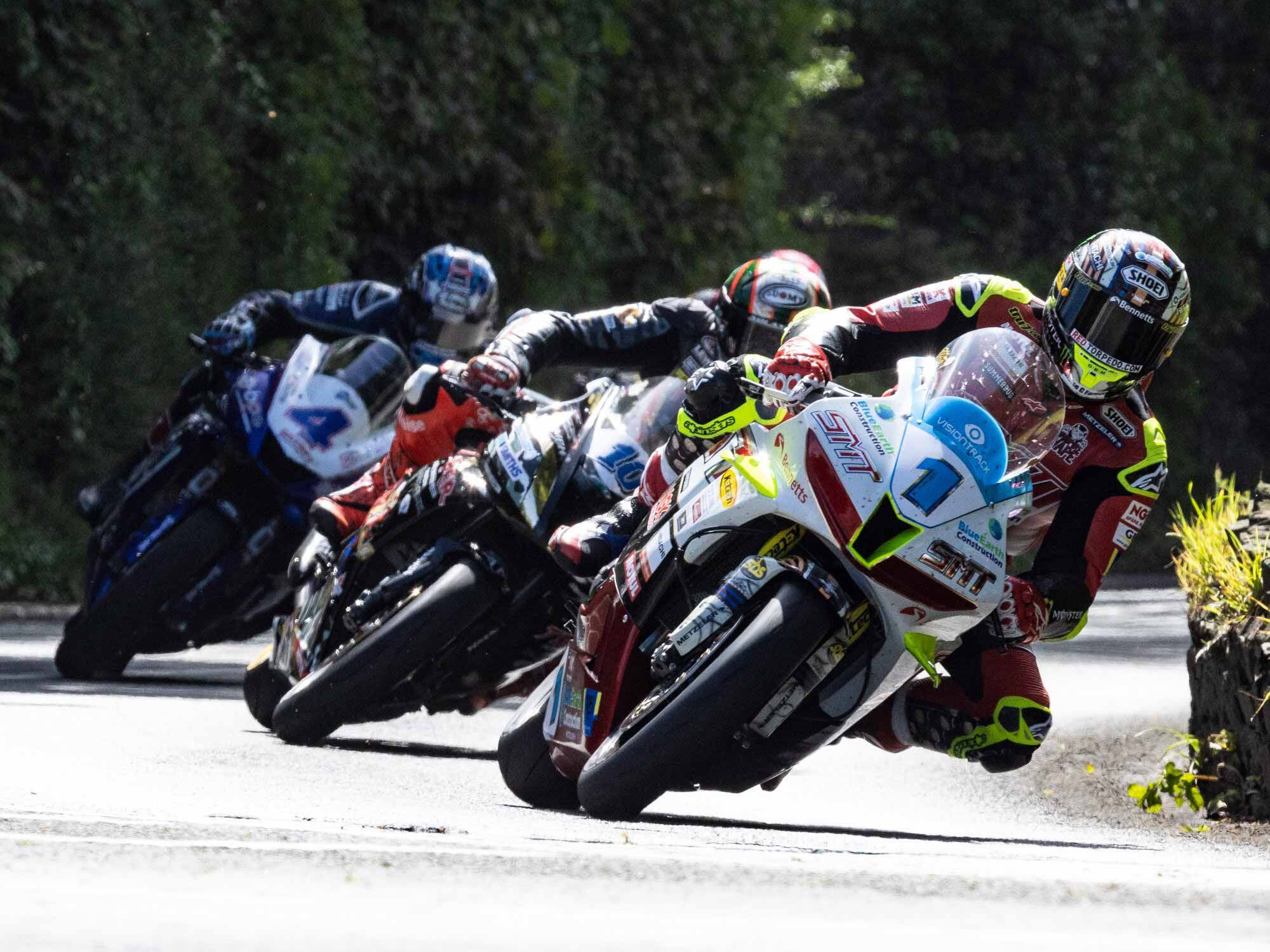 With riders leaving the start every 10 seconds, bunching up is rare. Coming into Greeba Bridge, McGuinness (1) leads Hickman (10) and Hutchinson (4). Hidden behind the group is Davey Todd (8).