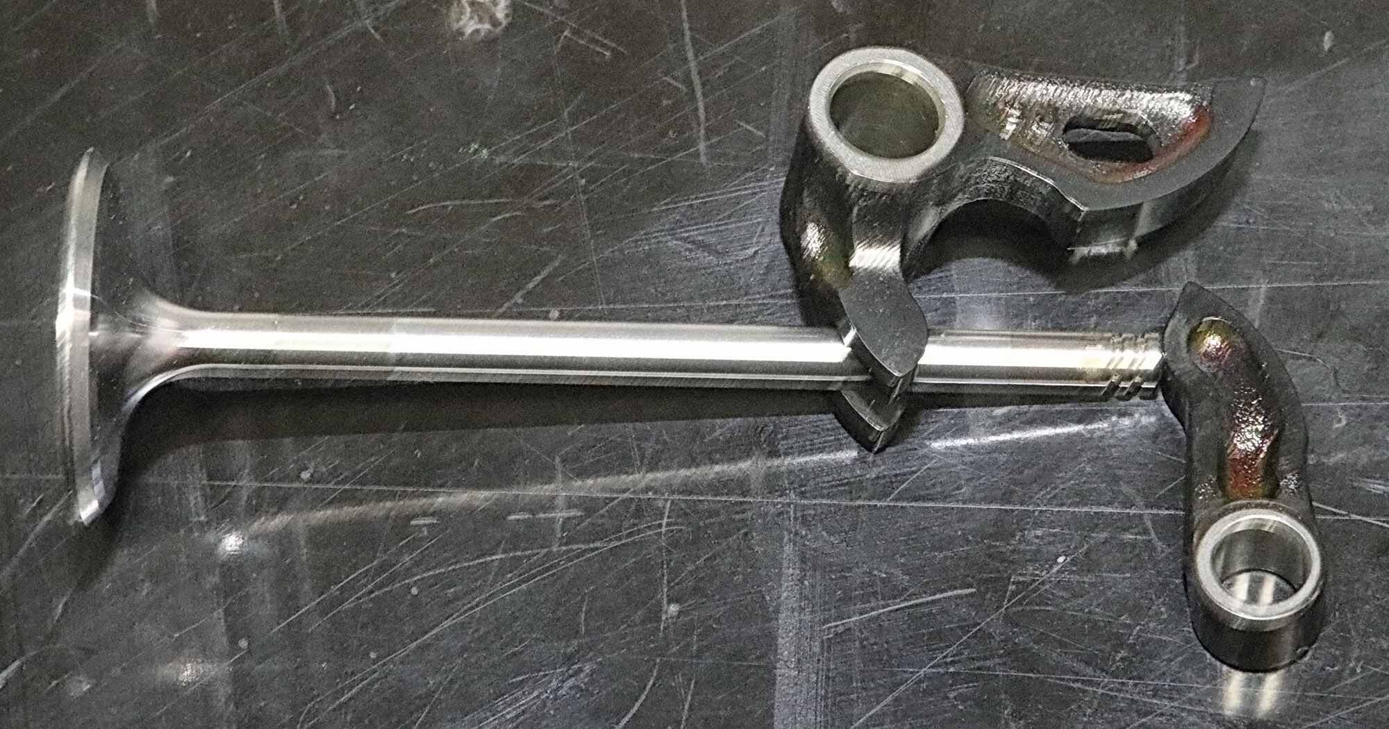 Desmo 101: A Panigale valve and its actuation train—the opening finger-type and the closing fork-type cam followers.