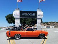 nick ienatsch el camino parked in front of laguna seca raceway sign