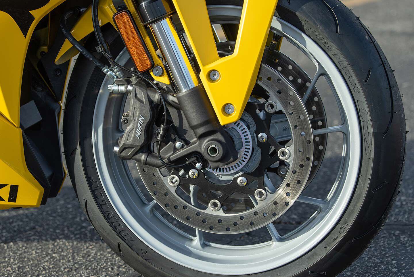 Nissin radial-mount four-piston calipers are shared with the 8S.