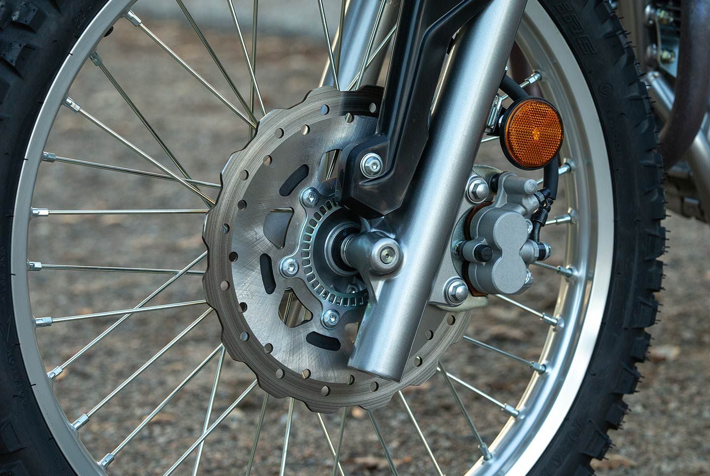 The ABS-equipped model features a 265mm rotor with a dual-piston caliper while the standard model utilizes a 240mm rotor. ABS can not be disabled on the front brake.