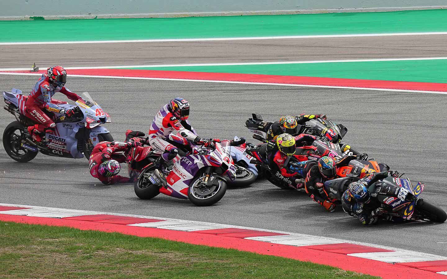 In an effort to not lose time at the start of a race, riders are risking quite a bit when heading into the first corner. In Catalunya, Enea Bastianini made contact with Johann Zarco, leading to a multi-bike incident.