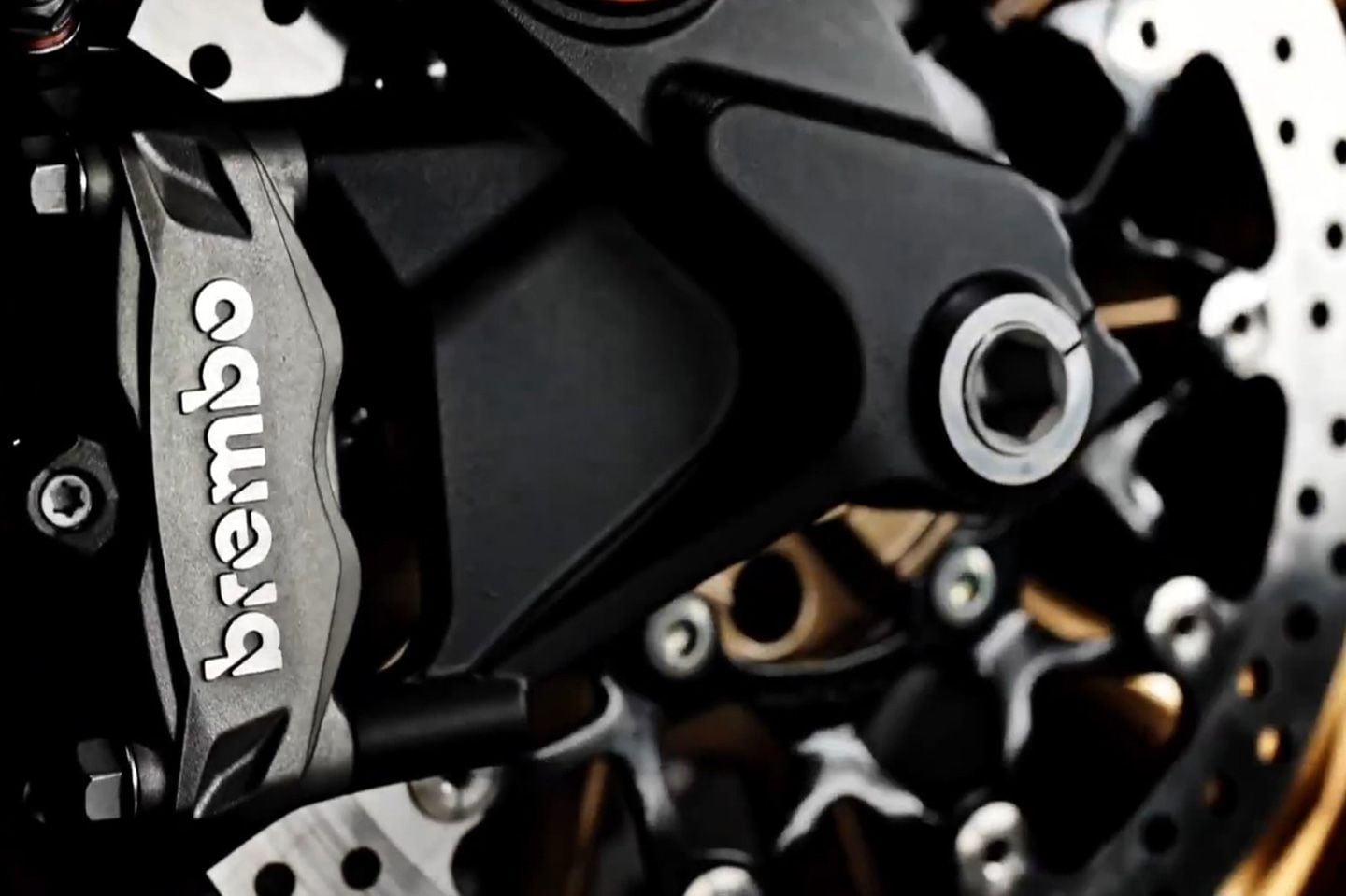 Brembo radial-mount, four-piston calipers are used up front.
