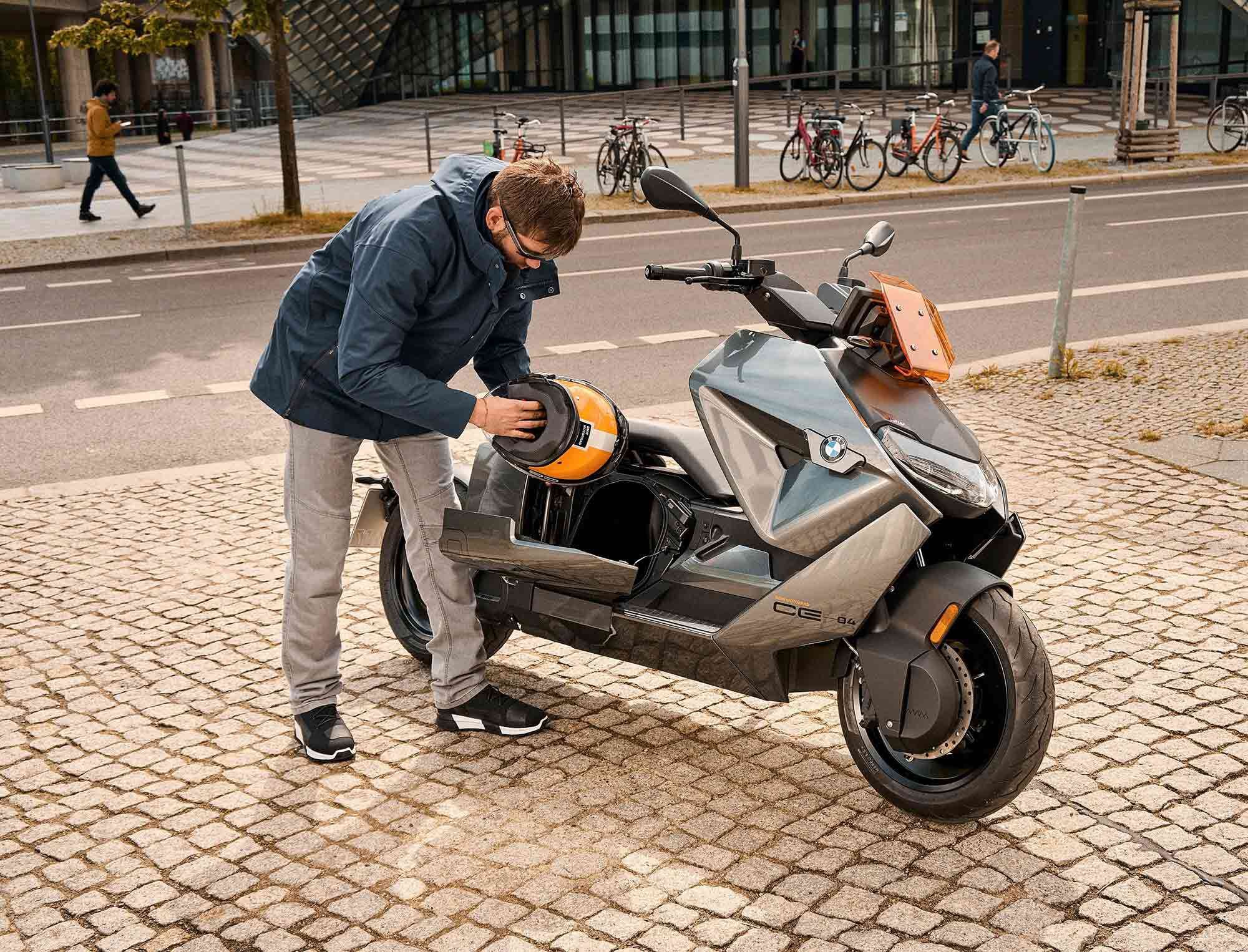 Main storage on the CE 04 is a side-opening underseat cubby large enough to cram a full-face helmet into.