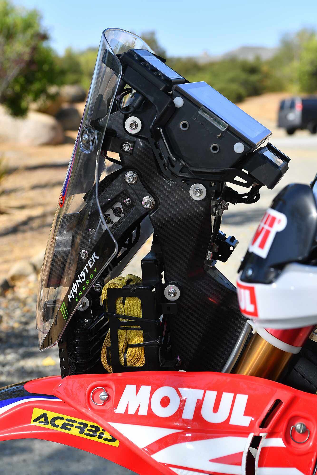 This profile view of the Toray Carbon Magic carbon fiber nav tower shows that it’s bolted to the steering head, and even without the instruments in place, it provides a fairly even surface in the interests of rider safety. Note, too, the tow strap for emergencies. The spare throttle can be affixed to this side as well.