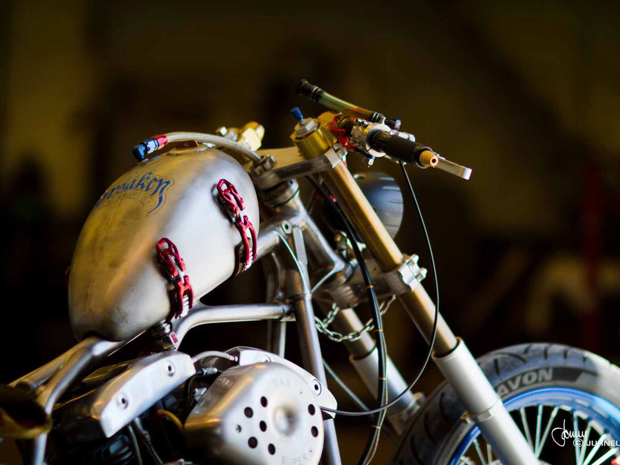 That gas tank breather line looks like it came from Earl’s Supply, whose braided steel hoses have adorned so many roadracers. In counterpoint, cast your eye over steering stops implemented with chain.