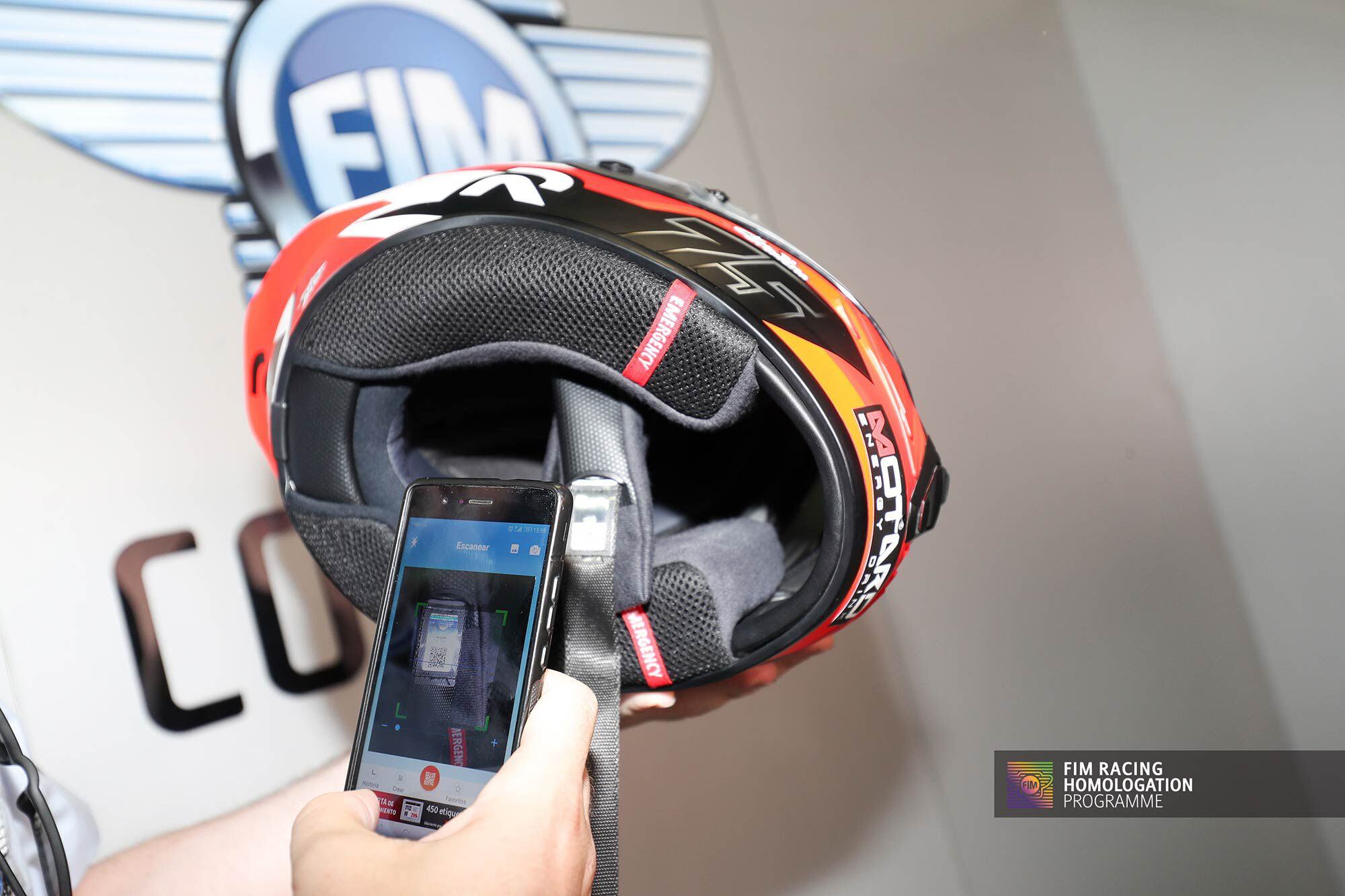Here an FIM inspector scans former Moto3 world champ and current Moto2 rider Albert Arenas’ helmet strap QR code.