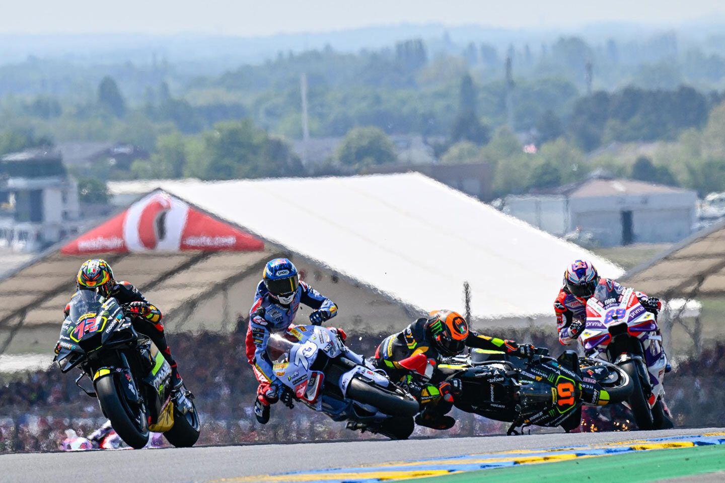 Luca Marini nearly saved a front-end tuck in turn 4 on Sunday, but ultimately collided with Álex Márquez in a scary incident that both riders were lucky to walk away from. Bezzecchi squeezes by.