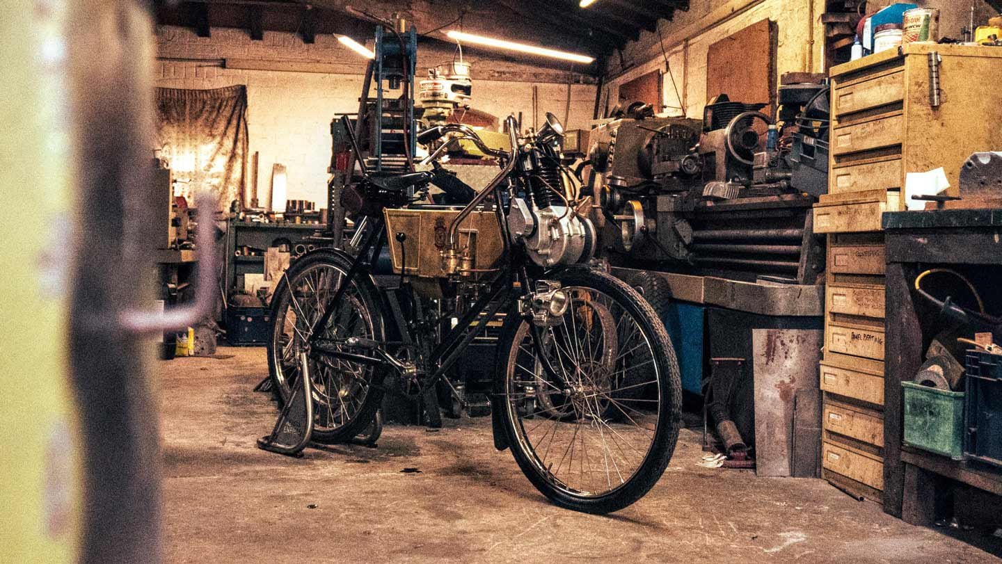 A period-correct motorized bicycle deserves a period-correct murky workshop. Project Origin patiently awaiting its closeup.