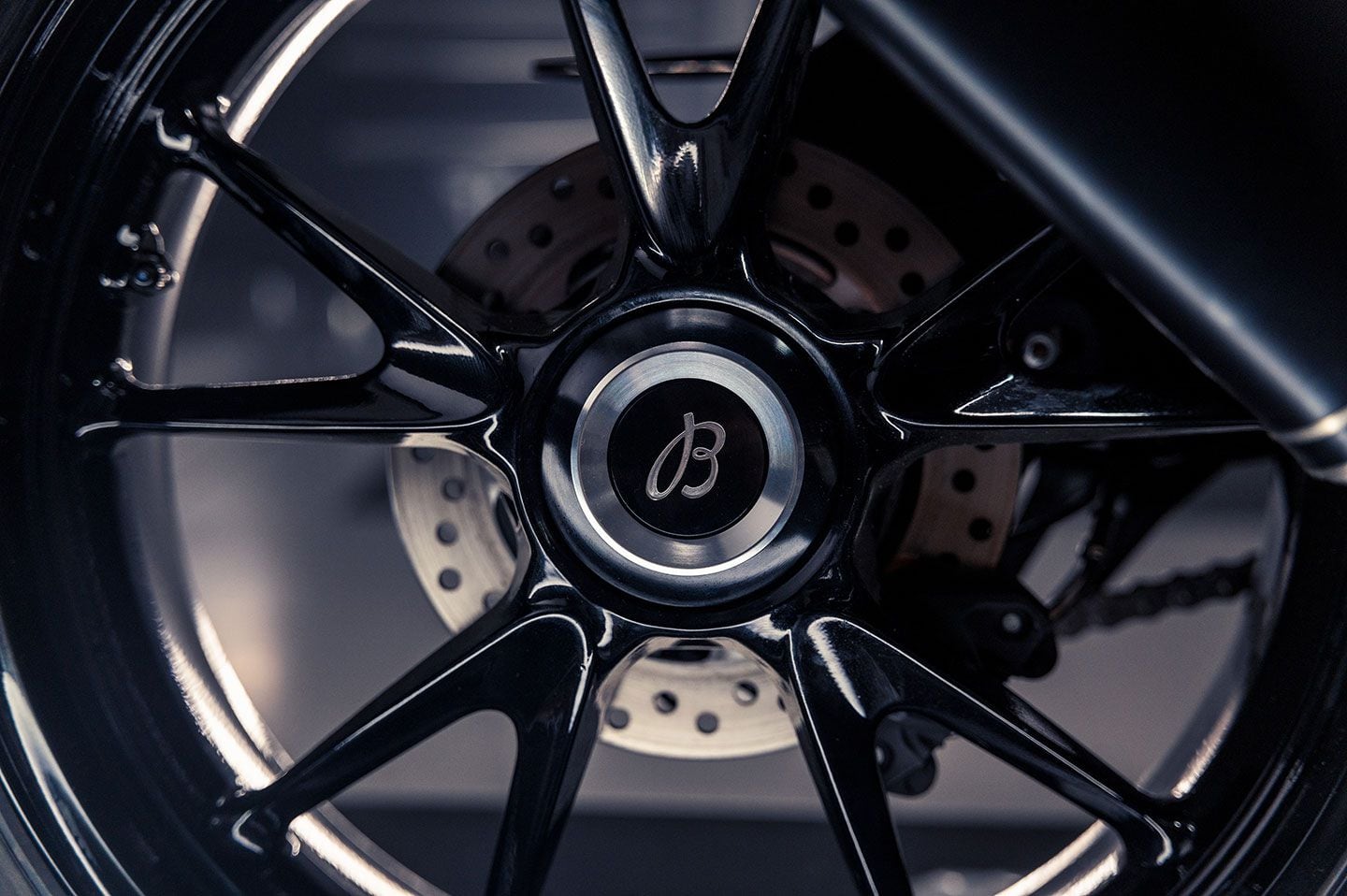 The rear wheel features a laser-etched Breitling logo on the hub cover.
