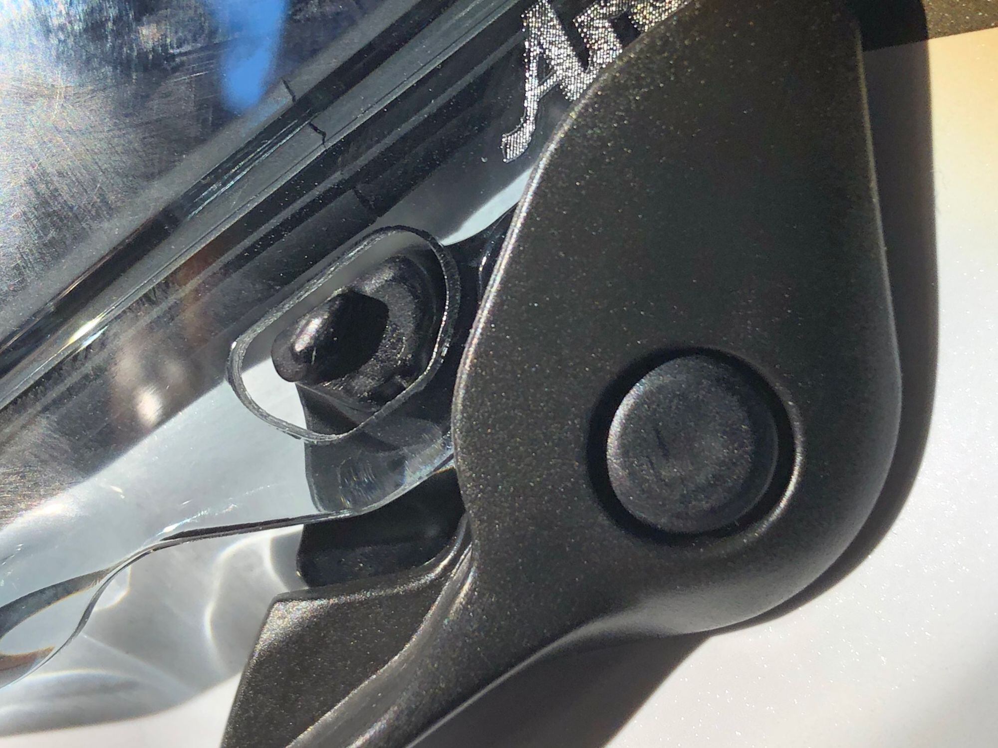 The VAS latch captures the shield to hold it closed but the shield occasionally gets caught on it, interfering with a smooth open or close.