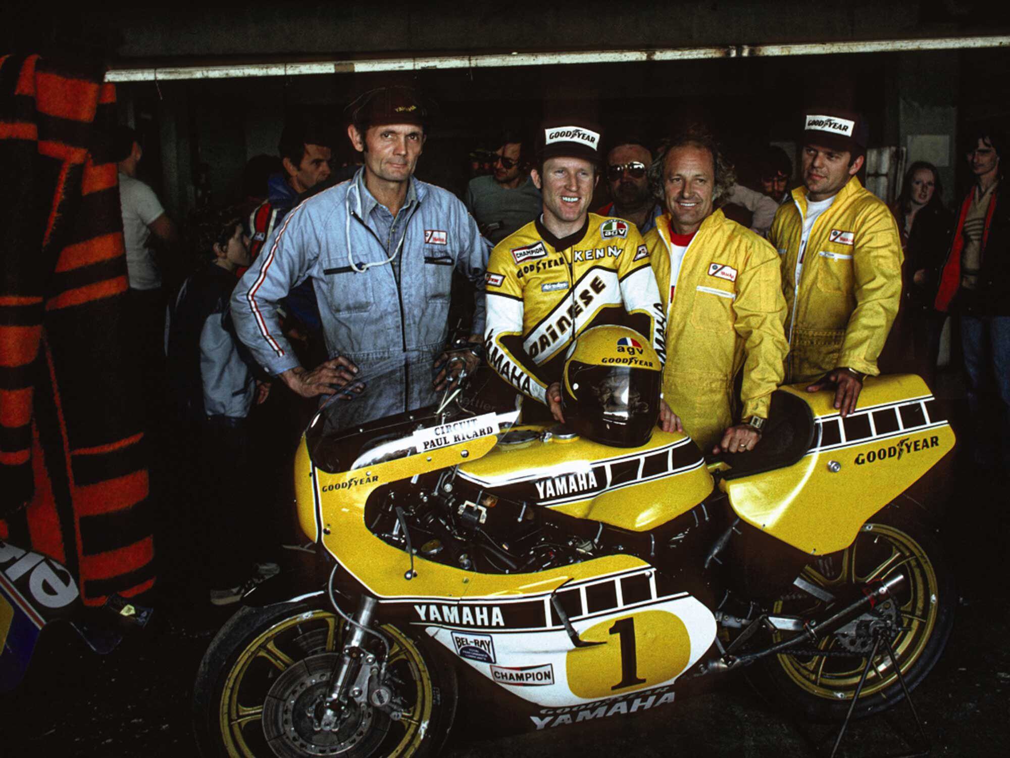 Three races, three wins. This is May 1980, Paul Ricard Circuit in the south of France. Roberts stands with his crew—Nobby Clark on his right, and Kel Carruthers and Trevor Tilbury on his left.
