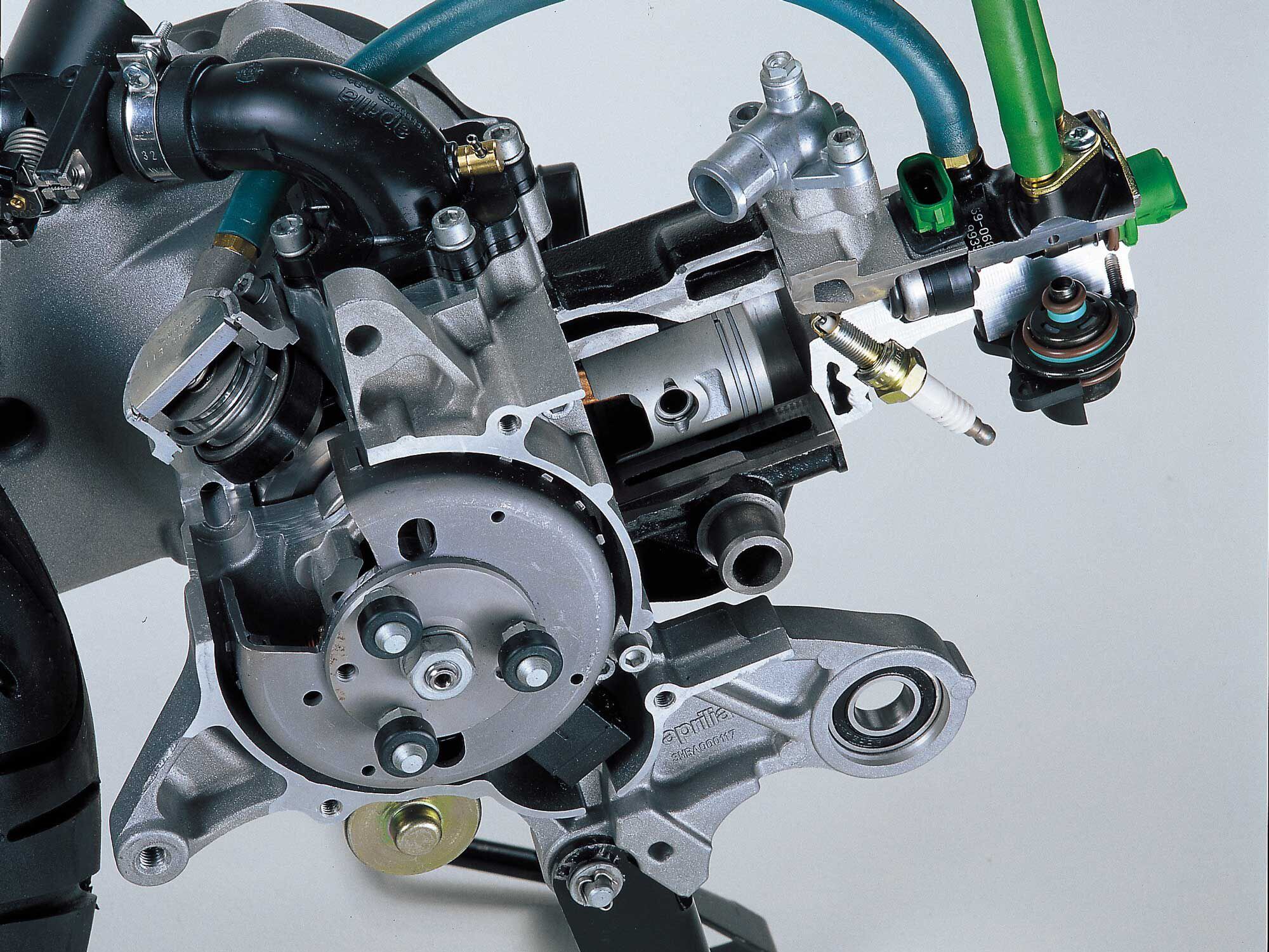 The heart of Aprilia’s fuel-injected two-stroke incorporates a fuel injector above the combustion chamber, as well as a provision for injecting compressed air.