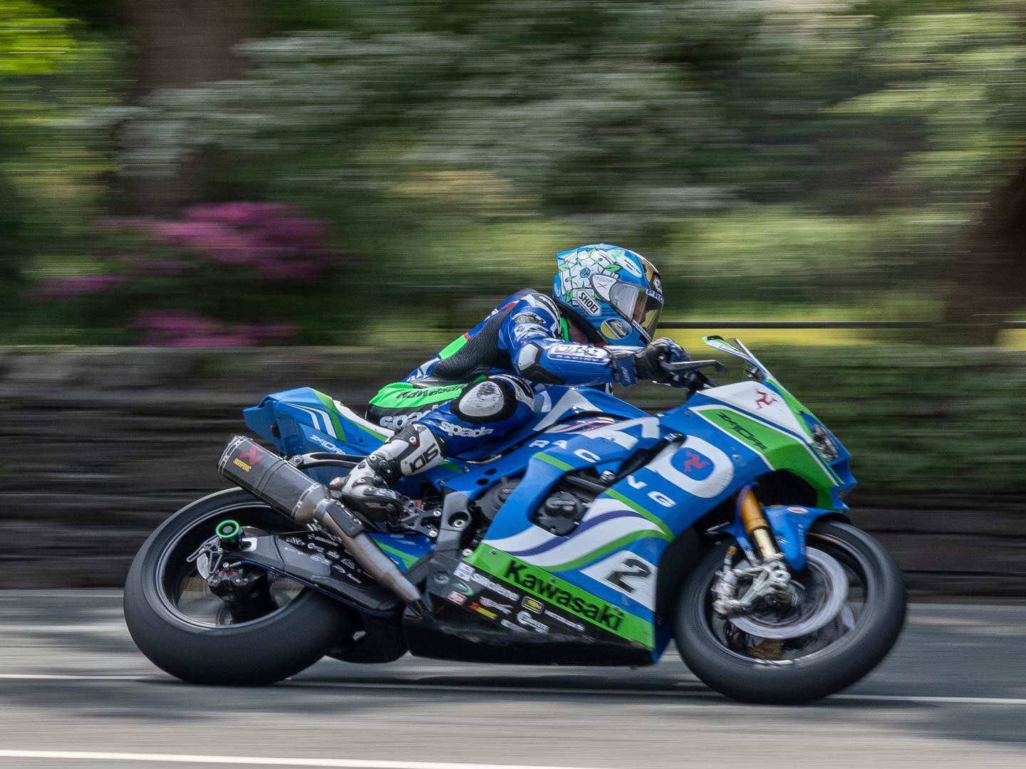 Always competitive, former TT Senior Superbike winner Dean Harrison rides his Kawasaki Ninja ZX-10RR Superbike close to the wall at Greeba Bridge. Harrison finished second to Hickman, 20 seconds back after six laps and two pit stops of the 37.73-mile course.