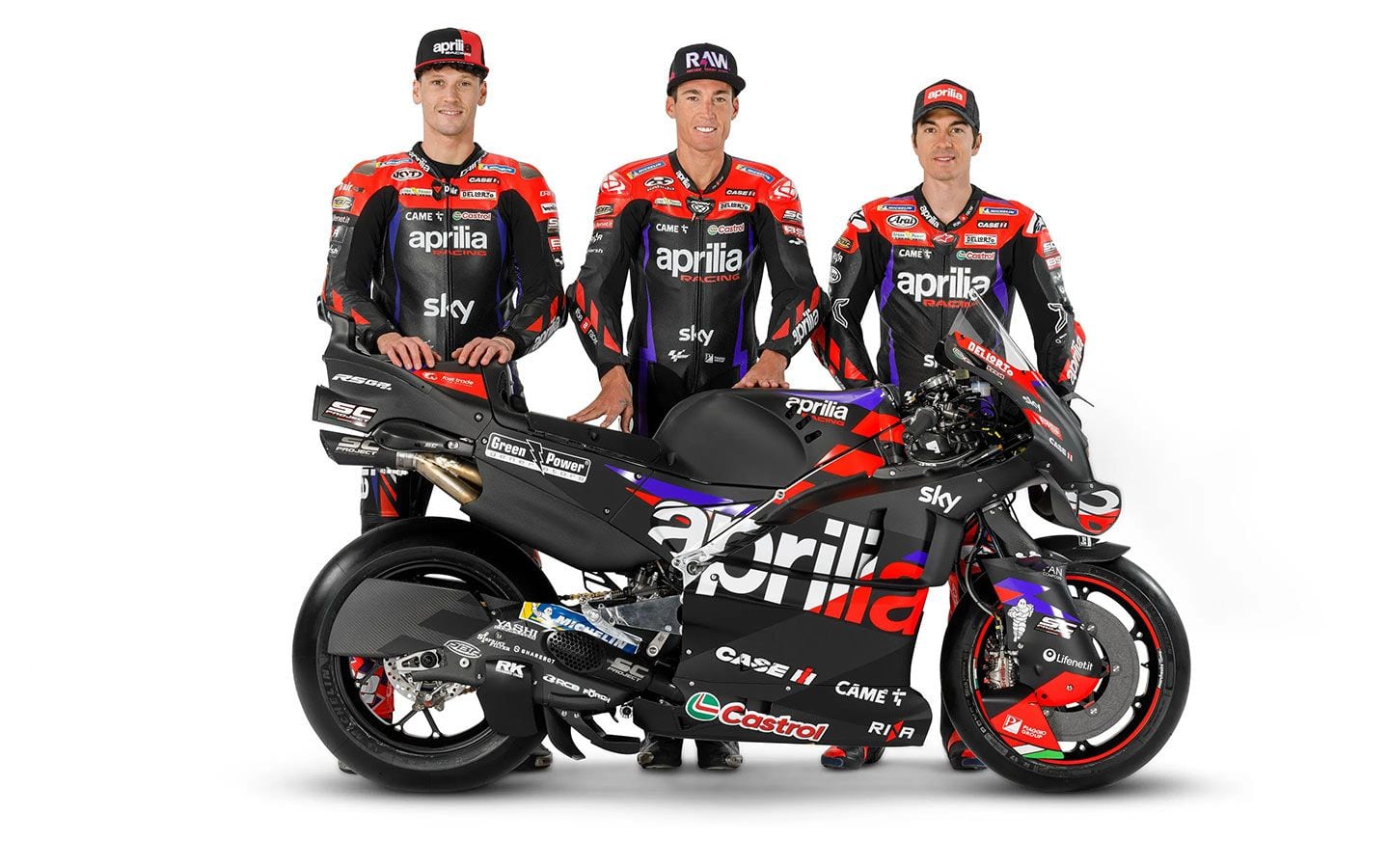 Left to Right: Lorenzo Savadori (official test rider), Espargaró, and Viñales stand behind their latest racebike: the Aprilia RS-GP24.