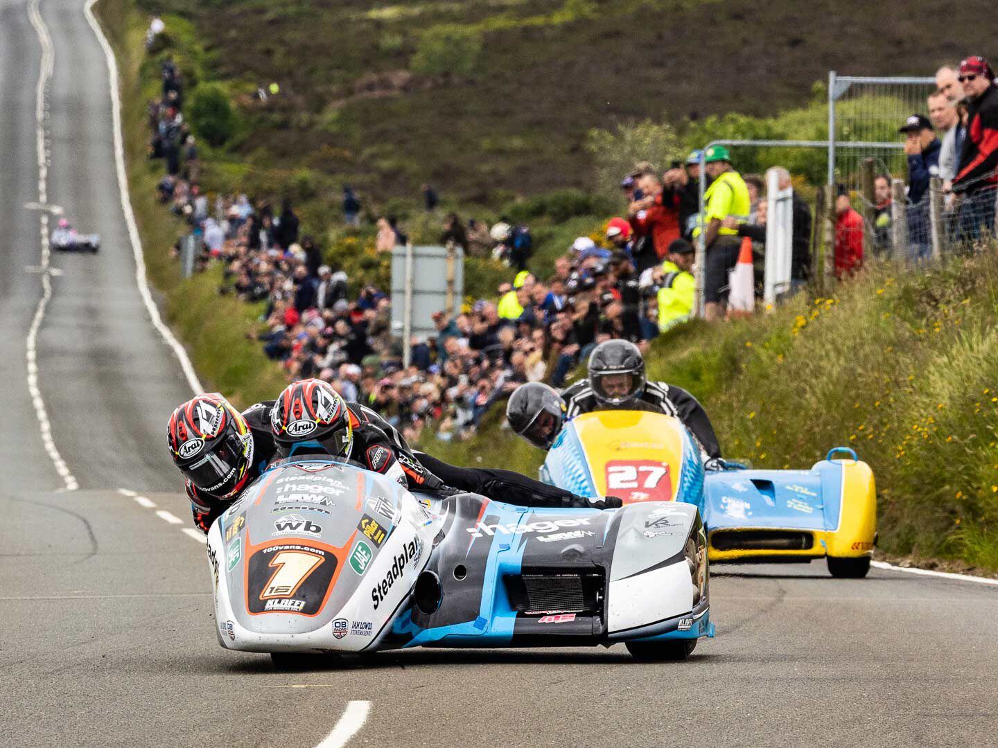 Ben and Tom Birchall en route to their 14th consecutive TT win, passing Creg-Ny-Baa 3 miles from the finish line. Tom leans over Ben to optimize the balance of the sidecar.