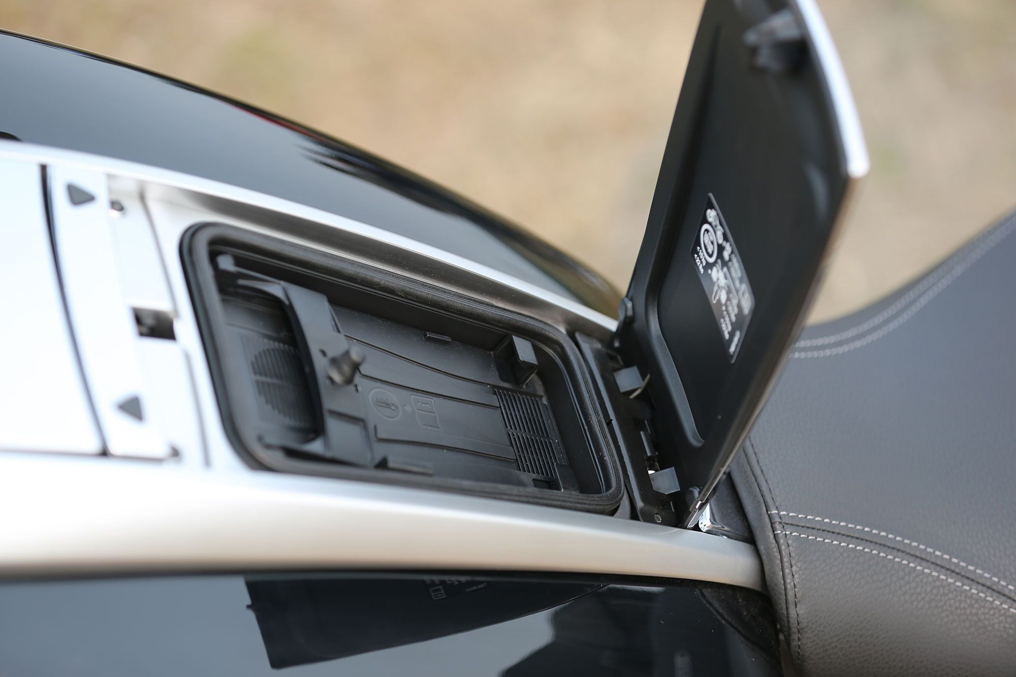 Located behind the gas cap is a phone storage compartment with wireless charging.