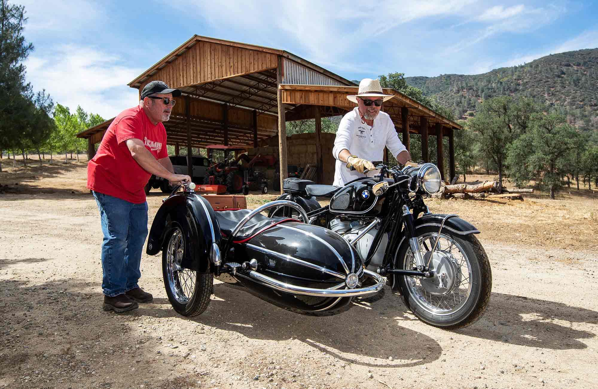 David Hostetter (right) and friend Greg Heiss wheel Haith’s beloved 1962 BMW R60/2, with its Steib sidecar, into the sunlight.