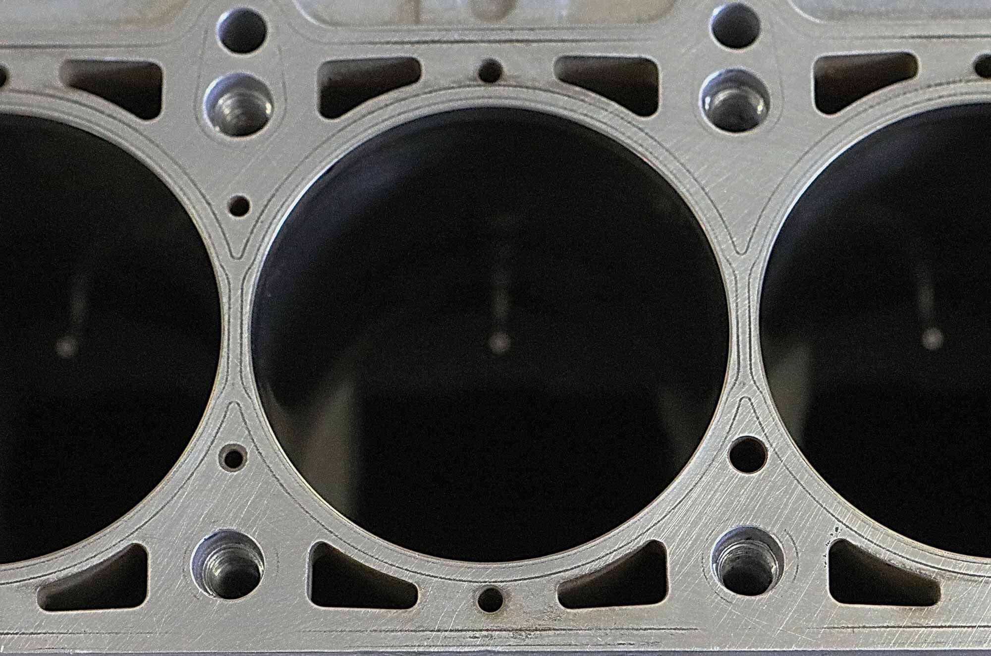 At 81mm, the 950’s cylinder bores are 2mm larger than the 800’s. To make them fit and keep the engine narrow, the cylinder barrels are integral to the aluminum block, Nikasil plated, and use a siamesed design. Center-to-center bore spacing remains unchanged, a fundamental factor in keeping the new engine and its tooling costs competitively priced.