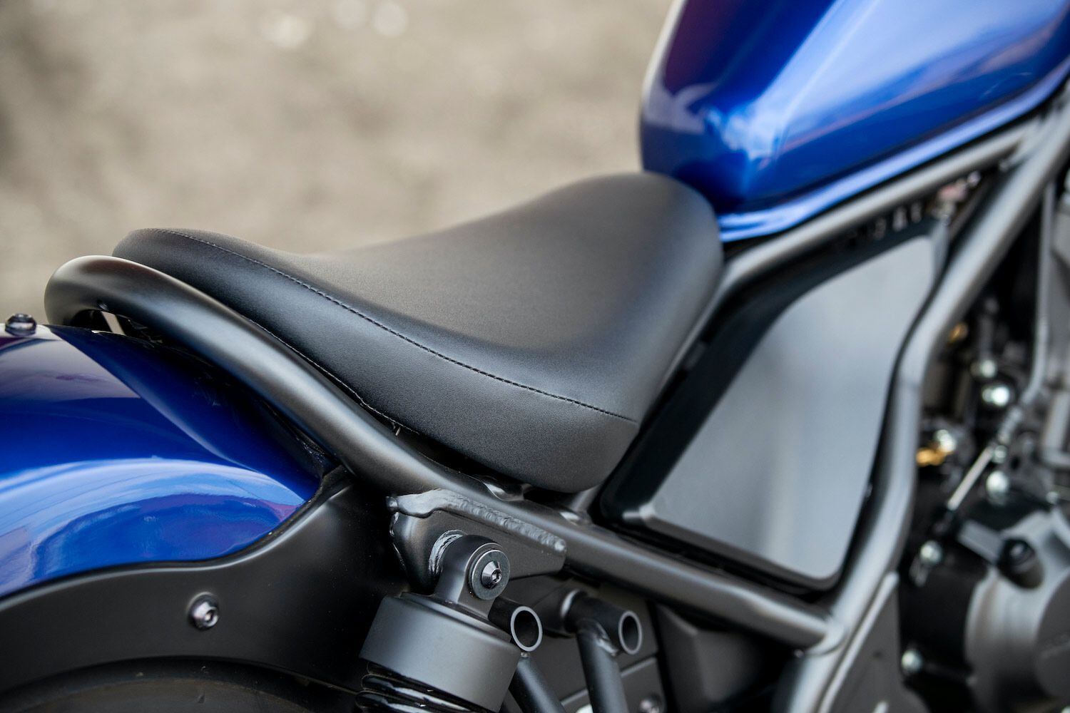 A solo saddle gives the Rebel its bobberlike look, but the firmness of the cushion is uncomfortable on longer rides.