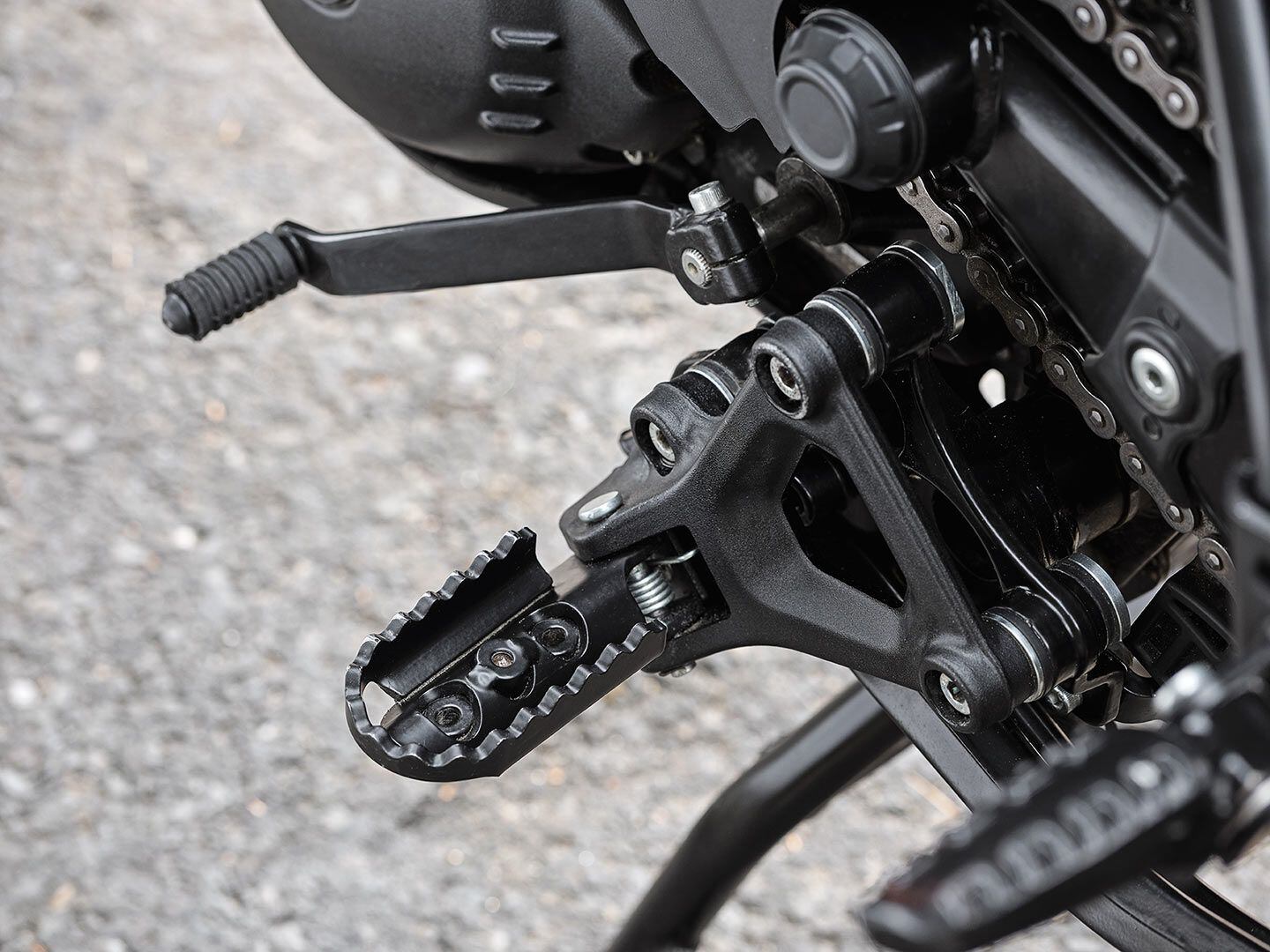 Two bolts allow the rubber footpeg inserts to be removed.