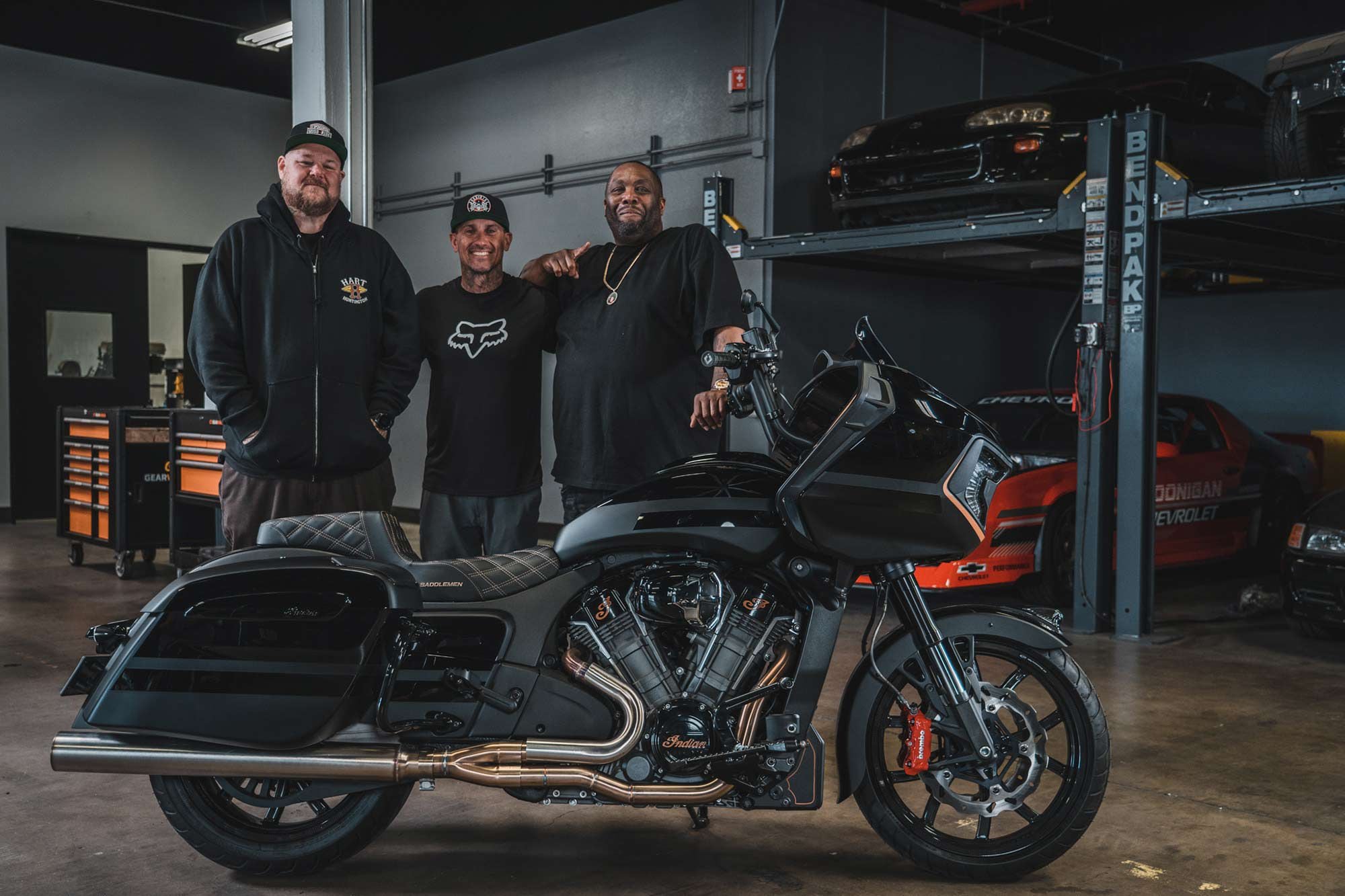 From left to right, Big B, Carey Hart, and Killer Mike pose with the custom-built Challenger.