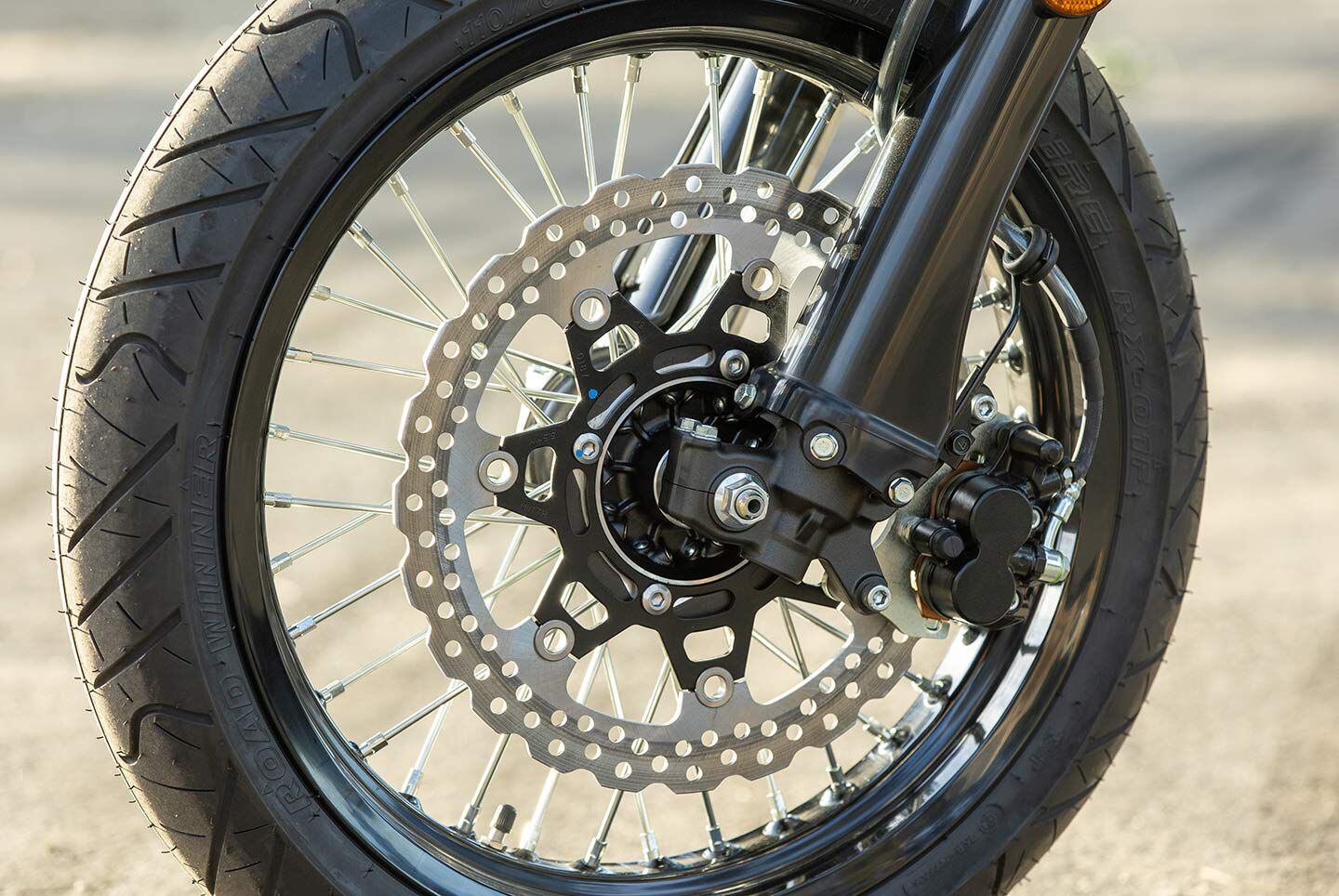 The 2024 Kawasaki KLX300SM utilizes a large 300mm front disc and dual-piston caliper.