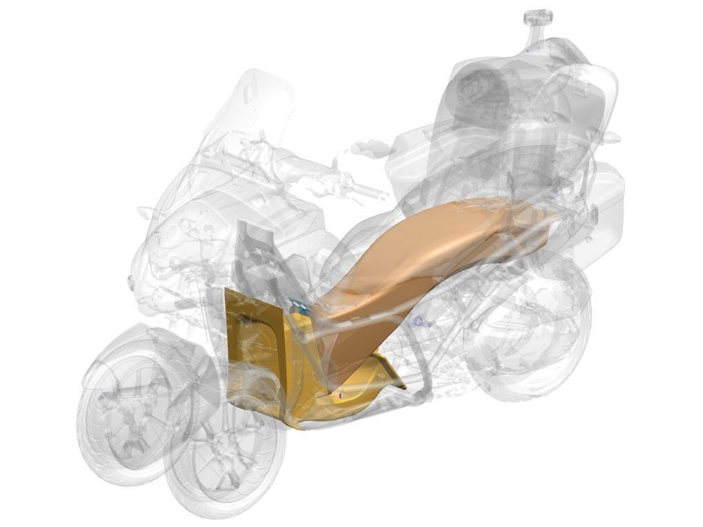 The duct’s intake is between the front wheels, from whence air is moved up over the engine and out through the tail.