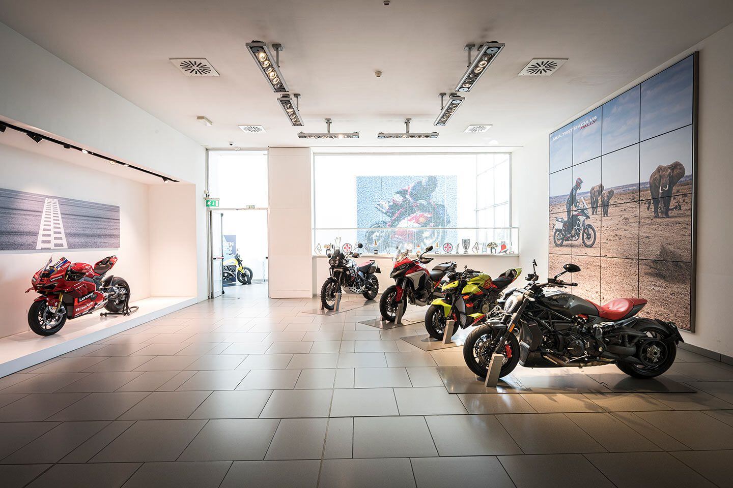 Ducati’s factory reception hall. Ducati points out that it was the first manufacturer to use the following technologies on production motorcycles: traction control, LED lighting, switchable riding modes, TFT displays, engine-braking control, D-air integrated airbag, slide by brake, front and rear radar, and extended cylinder deactivation.