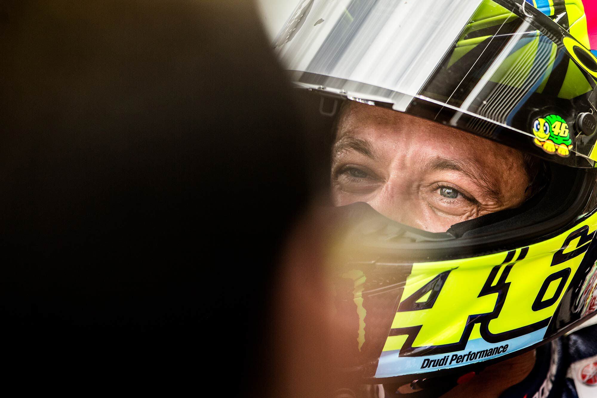 Rossi’s smile can be easily seen under his helmet.