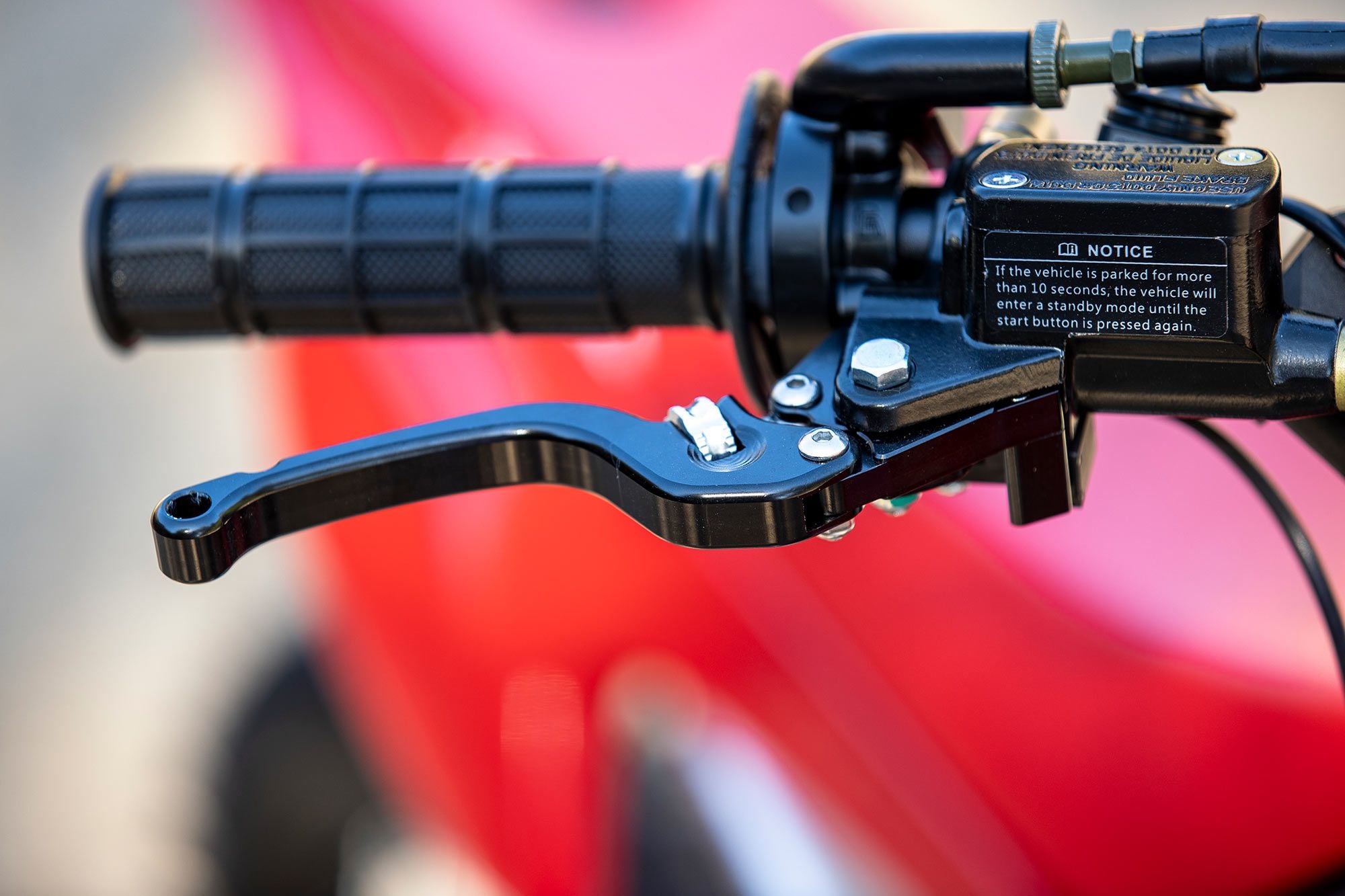 Front brake is on the right, rear brake is on the left. Levers feature “breakaway” notches at their ends and a very wide range of reach adjustment.