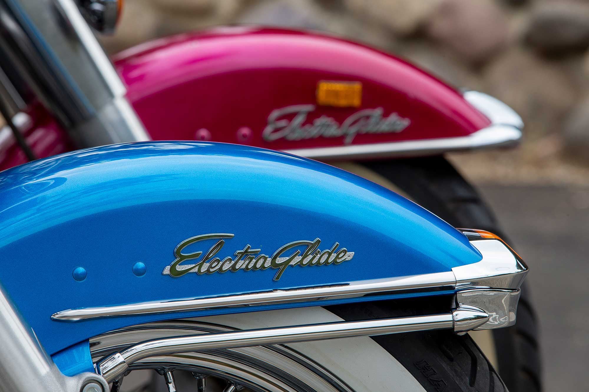 The classic Electra Glide insignia adorns the Revival’s front fairing and the FLH behind it.