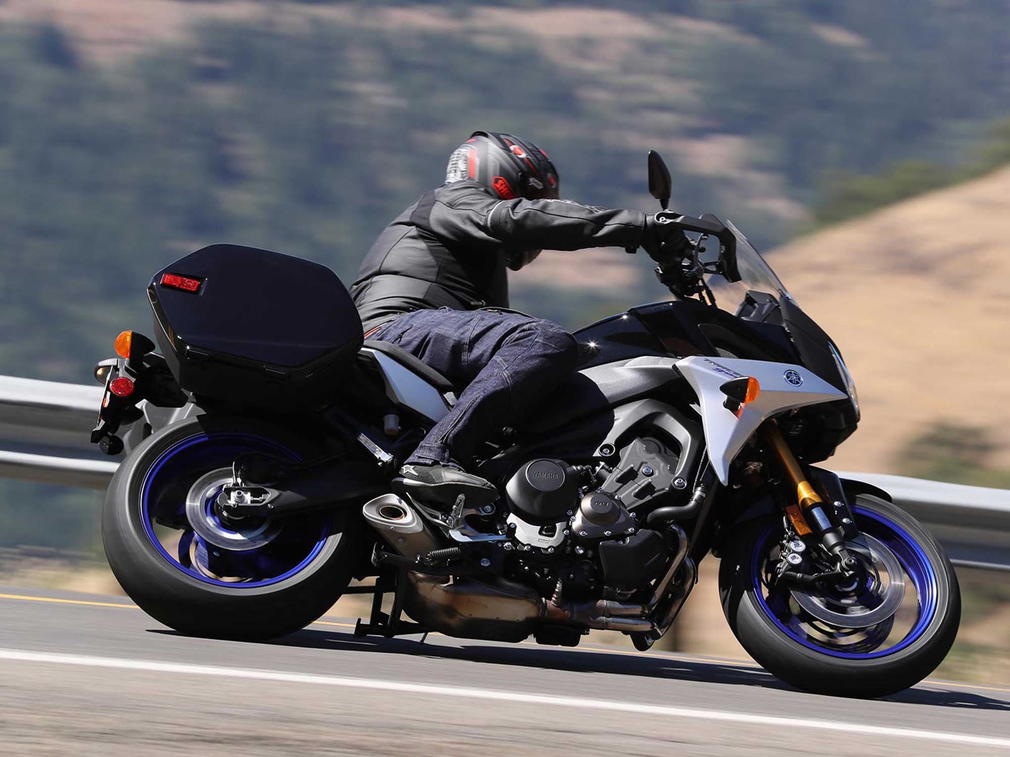 Look at the front suspension as the rider enters the turn—it’s loaded so that the tire can be loaded. The rider is smooth in their actions and is trailing off the brakes as the lean angle increases.