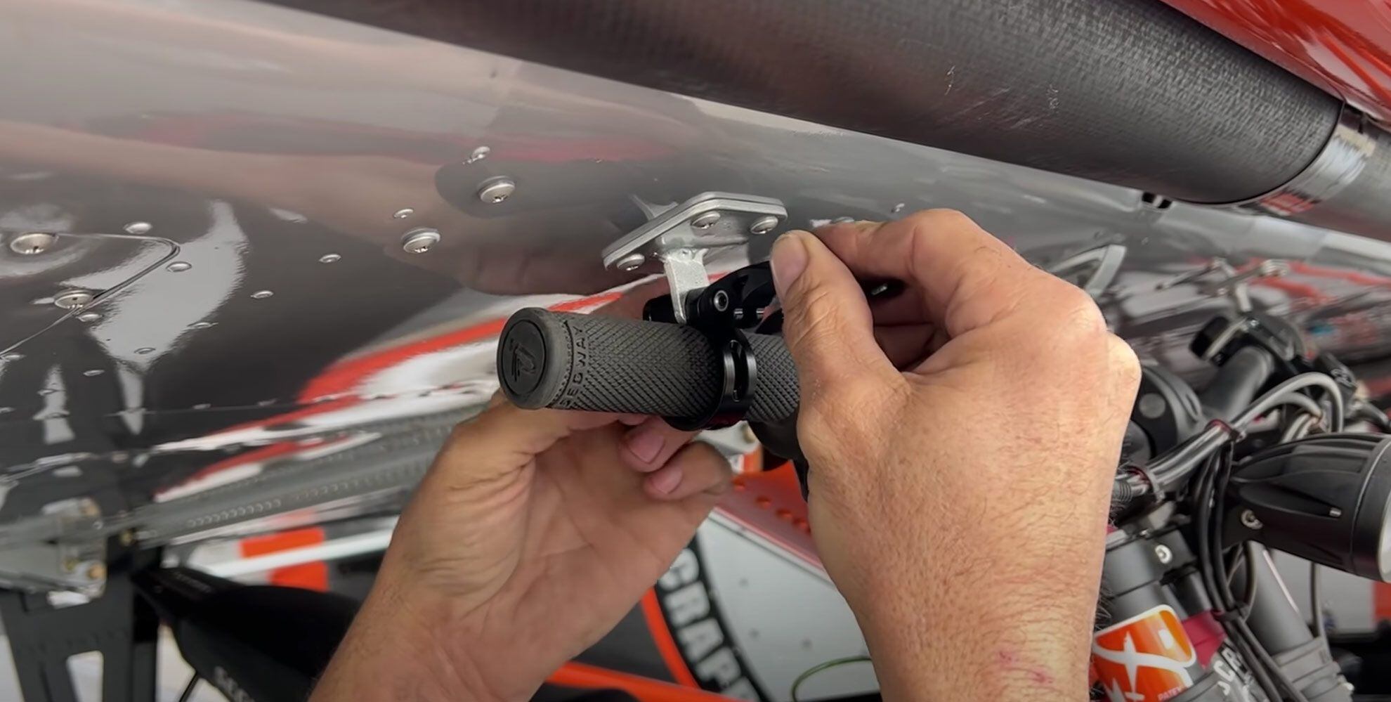 Mike Patey installs a special bracket on Scrappy’s wings that helps reduce drag while hauling the Segway X260s.