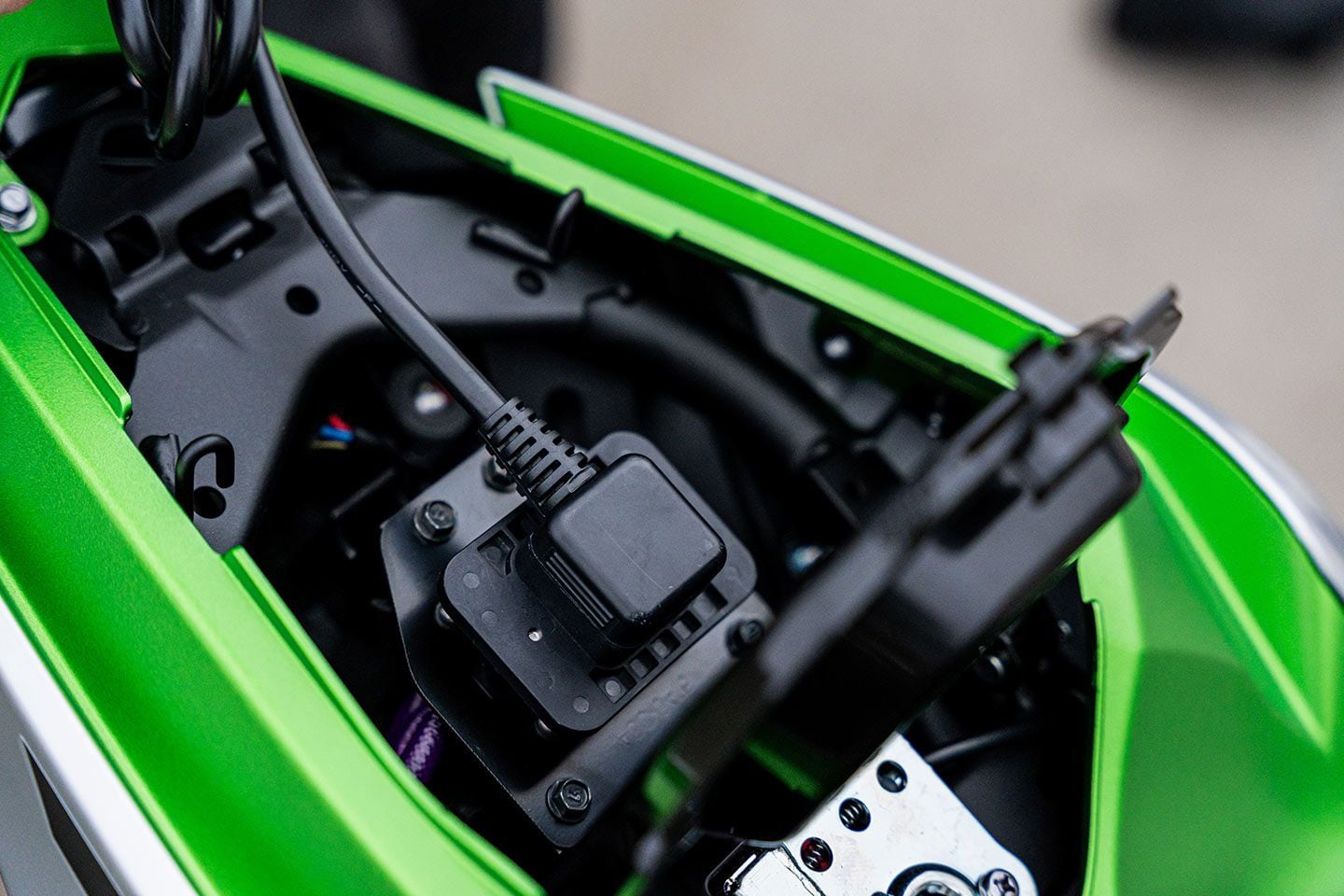 Batteries can be charged one at a time off the bike, or left in the bike and charged simultaneously, by plugging the charger into this charge port in the bike’s tailsection.