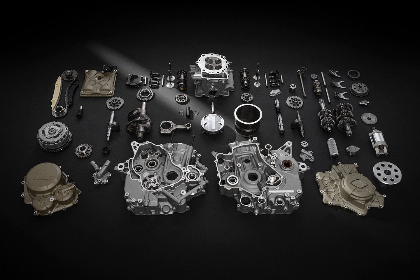 So many beautiful parts. The Superquadro Mono’s desmodromic valve gear is laid out next to the cylinder head, featured top dead center (see what we did there?). Deep ribs in the castings give strength; magnesium covers reduce weight.