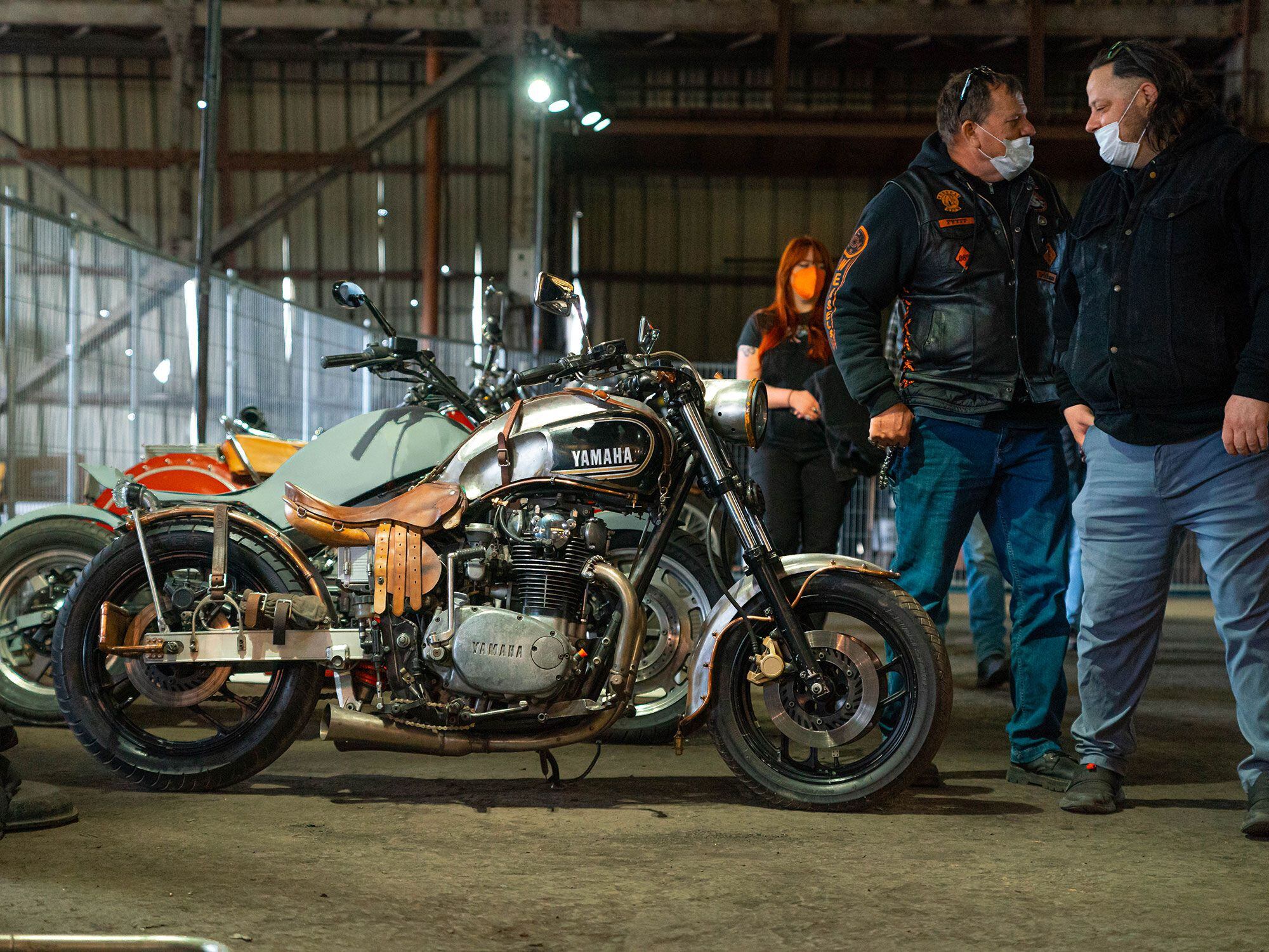 A custom 1974 Yamaha XS600 with copper and wooden accents sits in one of the corridors of the Barge Building.