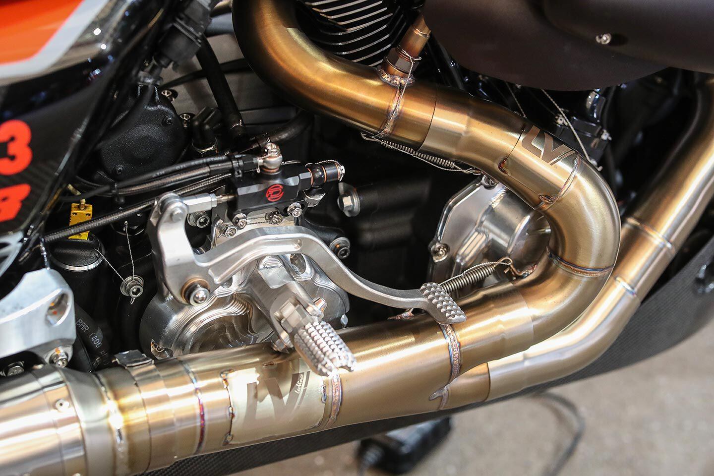 A low-slung exhaust won’t do in bagger racing—every degree of lean angle is needed. Harley engineers have routed the factory racers’ exhaust as high and tight as possible.