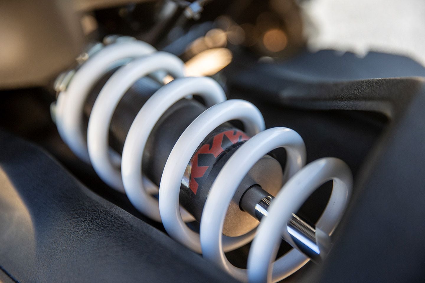 The rear shock provides remote reservoir four-position compression damping adjustment as well as preload adjustment.