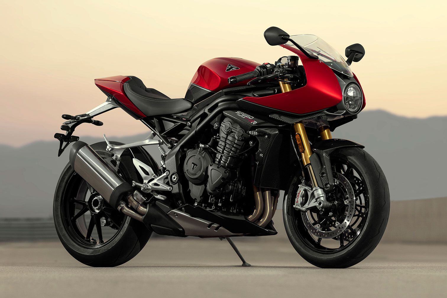 Triumph’s 2022 Speed Triple 1200 RR brings more sportbike character with a half fairing, clip-ons, and Öhlins electronic suspension.