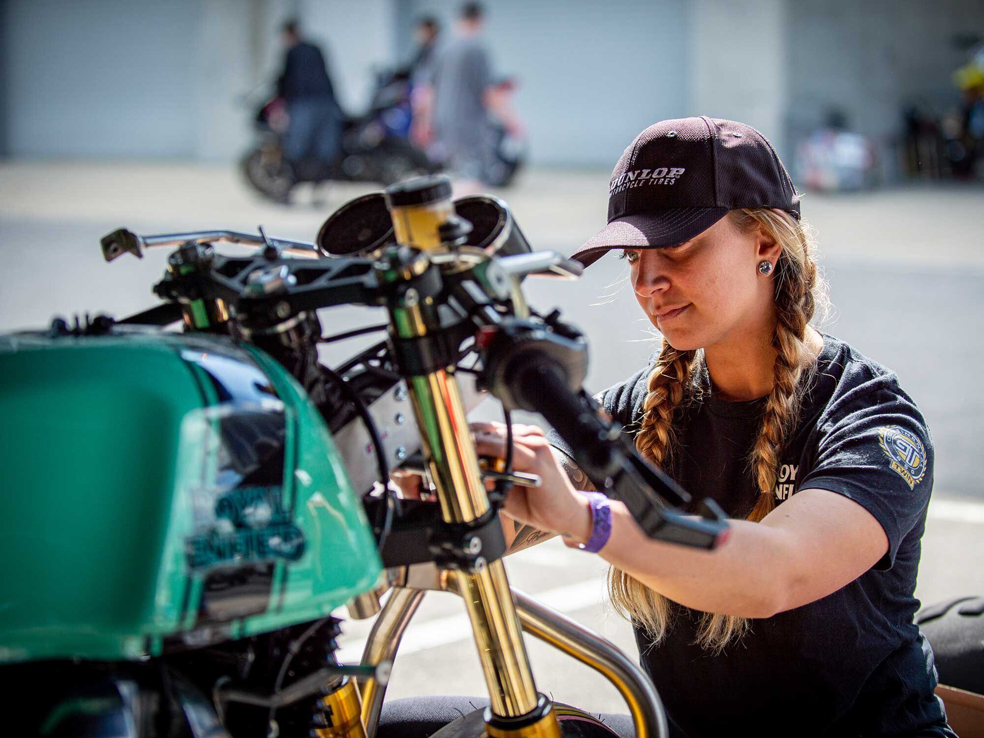 The BTR women do their own wrenching in the paddock, as Buyck demonstrates.