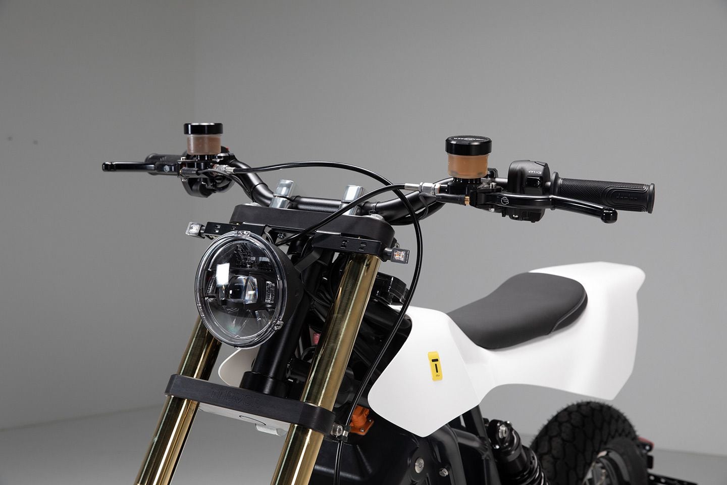 LED lighting and an aluminum flat-track-style Domino Racing bar define the front end.