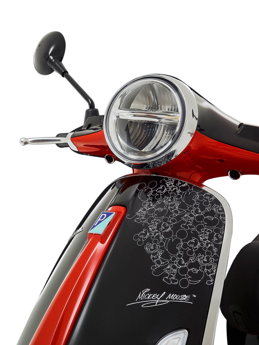 The graphic treatment also includes white silhouettes of the mouse on the front steel shell and an autograph.
