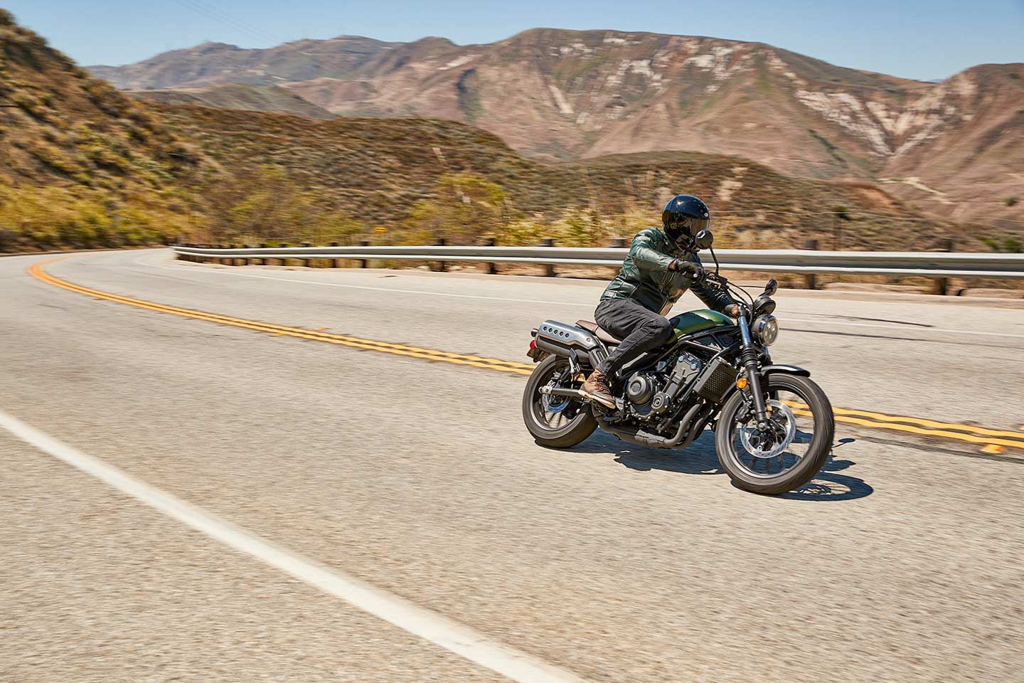 The 2023 Honda SCL500 is right at home against a scenic backdrop.